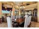 Gourmet dining area with a large table, chandelier, and built-ins at 9782 E Troon North Dr, Scottsdale, AZ 85262