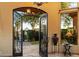 View from inside the home, showcasing a courtyard and gate at 9782 E Troon North Dr, Scottsdale, AZ 85262