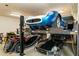 Garage with car lift and multiple vehicles at 9782 E Troon North Dr, Scottsdale, AZ 85262