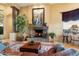 Living area showcasing a stone fireplace, large artwork, and comfortable seating at 9782 E Troon North Dr, Scottsdale, AZ 85262