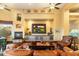 Living room boasts a fireplace, large TV, and comfortable seating at 9782 E Troon North Dr, Scottsdale, AZ 85262