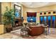 Spacious living room featuring a fireplace, large windows, and comfortable leather seating at 9782 E Troon North Dr, Scottsdale, AZ 85262