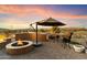 Outdoor patio with fire pit, grill, and seating area at 9782 E Troon North Dr, Scottsdale, AZ 85262