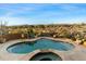 Inviting kidney-shaped pool with a spa and scenic views at 9782 E Troon North Dr, Scottsdale, AZ 85262