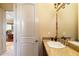 Powder room with granite countertop and decorative mirror at 9782 E Troon North Dr, Scottsdale, AZ 85262