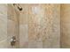 Shower with beige tile and decorative mosaic accents at 9782 E Troon North Dr, Scottsdale, AZ 85262