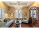 Sitting room with light colored sofa and wood flooring at 9782 E Troon North Dr, Scottsdale, AZ 85262
