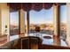 Wet bar with granite countertop, wine cooler, and scenic views at 9782 E Troon North Dr, Scottsdale, AZ 85262