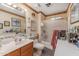 Clean bathroom with shower/tub combo and wood vanity at 13106 W Lyric Dr, Sun City West, AZ 85375