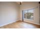 Bright bedroom with light hardwood floors and large window at 14741 W Avalon Dr, Goodyear, AZ 85395