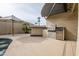 Outdoor kitchen with stainless steel appliances and pergola at 14741 W Avalon Dr, Goodyear, AZ 85395