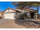 Single-story home with a two-car garage and desert landscaping at 1490 E 11Th St, Casa Grande, AZ 85122