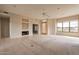 Living room with fireplace and large windows with scenic views at 15559 E Golden Eagle Blvd, Fountain Hills, AZ 85268