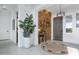 Bright and airy entryway with a wood accent wall and stylish decor at 17236 W Roseville St, Surprise, AZ 85388