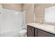 Clean bathroom featuring granite countertop, dark brown vanity, and bathtub at 18616 W Illini St, Goodyear, AZ 85338