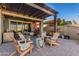 Relaxing backyard patio with covered seating area, artificial turf, and pergola at 19826 W Devonshire Ave, Litchfield Park, AZ 85340