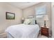 Bright bedroom with a full bed and nightstand at 19826 W Devonshire Ave, Litchfield Park, AZ 85340