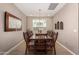 Elegant dining room with a large wooden table and chandelier, perfect for gatherings at 19826 W Devonshire Ave, Litchfield Park, AZ 85340