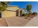 Single-story home with neutral siding, a two-car garage, and a landscaped front yard at 19826 W Devonshire Ave, Litchfield Park, AZ 85340