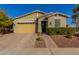 Single-story home with a two-car garage and well-manicured landscaping at 19826 W Devonshire Ave, Litchfield Park, AZ 85340