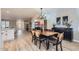 Modern dining room with wood table and stylish light fixture at 20414 N 124Th Dr, Sun City West, AZ 85375