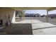 Covered carport with concrete flooring and gardening tools at 3950 N San Carlos Dr, Eloy, AZ 85131