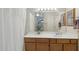 Clean bathroom with wood vanity and shower/tub at 4108 W Creedance Blvd, Glendale, AZ 85310