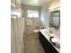 Clean and updated bathroom with a single vanity, shower/tub combo and new fixtures at 4302 E Evans Dr, Phoenix, AZ 85032