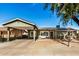 Green house with carport and landscaped yard at 4902 W Sheridan St, Phoenix, AZ 85035