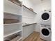 Laundry room with washer, dryer, and shelving at 7674 W Antelope Dr, Peoria, AZ 85383