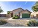 Single-story house with a green garage door and well-maintained landscaping at 9117 E Hillview Cir, Mesa, AZ 85207