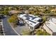 Modern home with solar panels and a large driveway, aerial view at 11380 E Sand Hills Rd, Scottsdale, AZ 85255