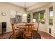 Bright breakfast nook with wood table and chairs, overlooking backyard at 1334 W Deer Creek Rd, Phoenix, AZ 85045