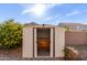 Tan metal storage shed with double doors at 13349 W Caribbean Ln, Surprise, AZ 85379