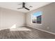 Bright bedroom featuring hardwood floors and a large window at 14126 S Diablo Rd, Arizona City, AZ 85123