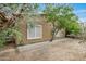 Backyard view showing a side of house with brick walkway and trees at 17132 W Tara Ln, Surprise, AZ 85388