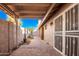 Covered patio, brick pavers, and a security door lead to a well-maintained backyard at 17633 N Lindner Dr, Glendale, AZ 85308