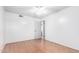 Simple bedroom with wood-look floors and access to bathroom at 17633 N Lindner Dr, Glendale, AZ 85308