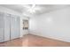 Light-filled bedroom with wood-look floors and double doors at 17633 N Lindner Dr, Glendale, AZ 85308