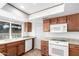 Modern kitchen with wood cabinets, granite countertops, and a breakfast bar at 17633 N Lindner Dr, Glendale, AZ 85308