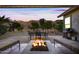 Relaxing backyard with a fire pit, patio furniture, and built-in grill at 2122 W Red Range Way, Phoenix, AZ 85085
