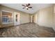 Spacious bedroom with wood-look tile floors and access to a patio at 2122 W Red Range Way, Phoenix, AZ 85085