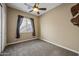 Well-lit bedroom featuring ceiling fan and carpet flooring at 2122 W Red Range Way, Phoenix, AZ 85085