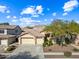 Two-story house with a three-car garage and mature trees at 2122 W Red Range Way, Phoenix, AZ 85085