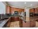 Spacious kitchen with an island, stainless steel appliances, and dark wood cabinets at 2122 W Red Range Way, Phoenix, AZ 85085