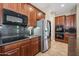 Modern kitchen with stainless steel appliances and dark wood cabinets at 2122 W Red Range Way, Phoenix, AZ 85085