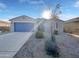 Single-story home with blue garage door and landscaped front yard at 2607 E Corazon Trl, Casa Grande, AZ 85194