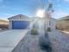 Single-story home with blue garage door and landscaped front yard at 2607 E Corazon Trl, Casa Grande, AZ 85194