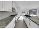 Modern kitchen boasting white cabinets, granite countertops and gas range at 2607 E Corazon Trl, Casa Grande, AZ 85194