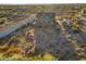 Aerial view of two-story house with large backyard and surrounding desert landscape at 27 N Muleshoe Rd, Apache Junction, AZ 85119